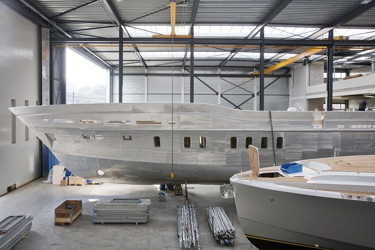 Large hull of a superyacht in a covered area