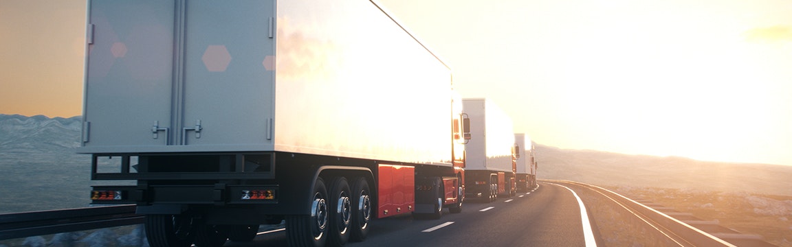 two trucks driving on highway