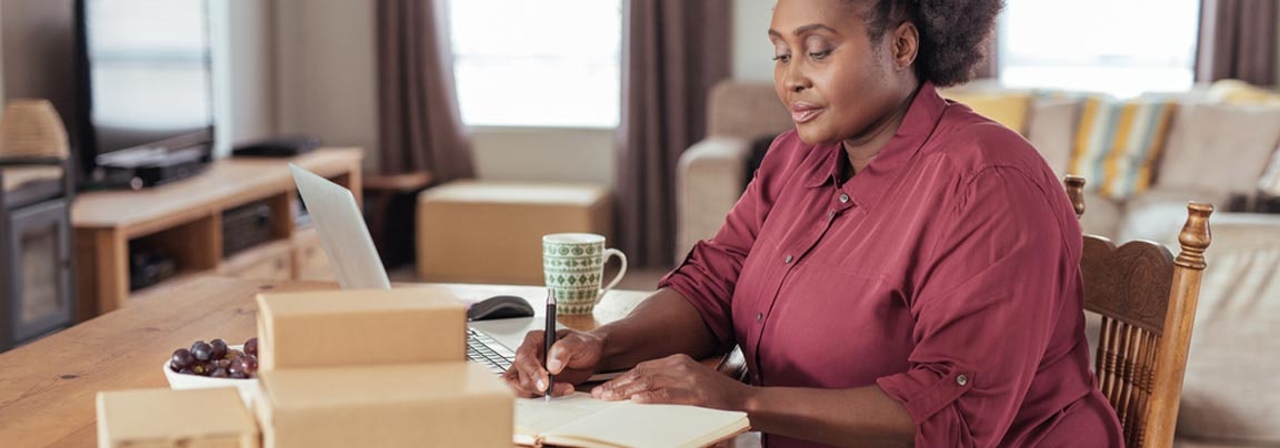 Woman working at desk, coffee cup in background