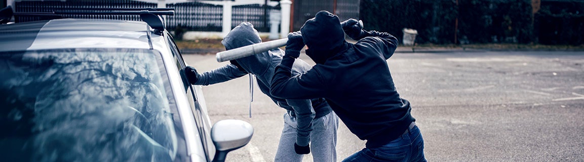 2 men breaking into a car