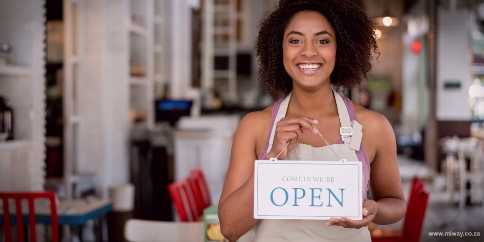Business owner holding a sign