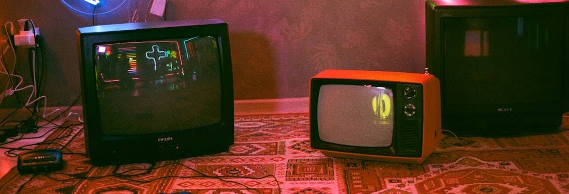 black crt tv on red and white floral textile
