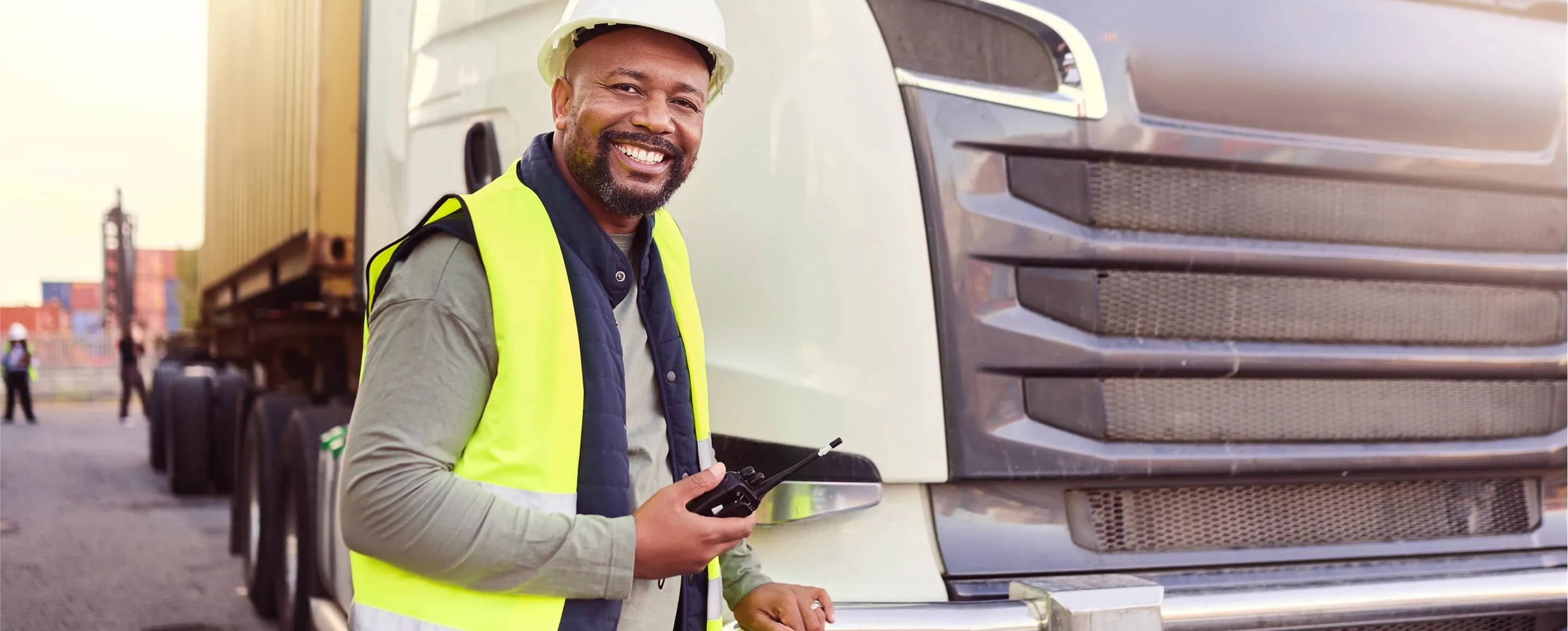 Truck driver standing in front of truck