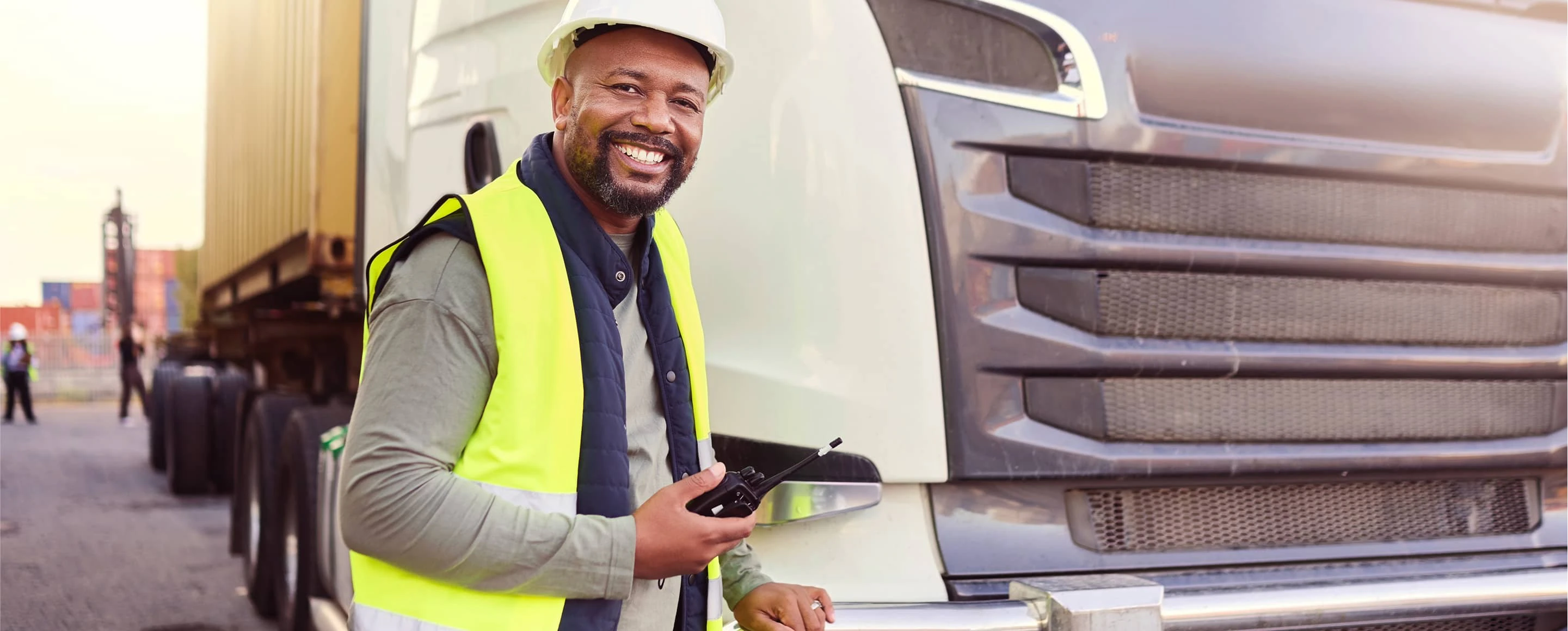 Truck driver standing in front of truck