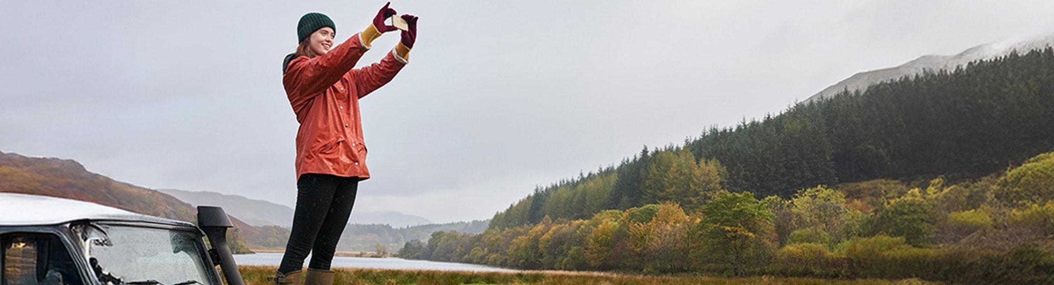 Man taking a picture of the view with cell phone