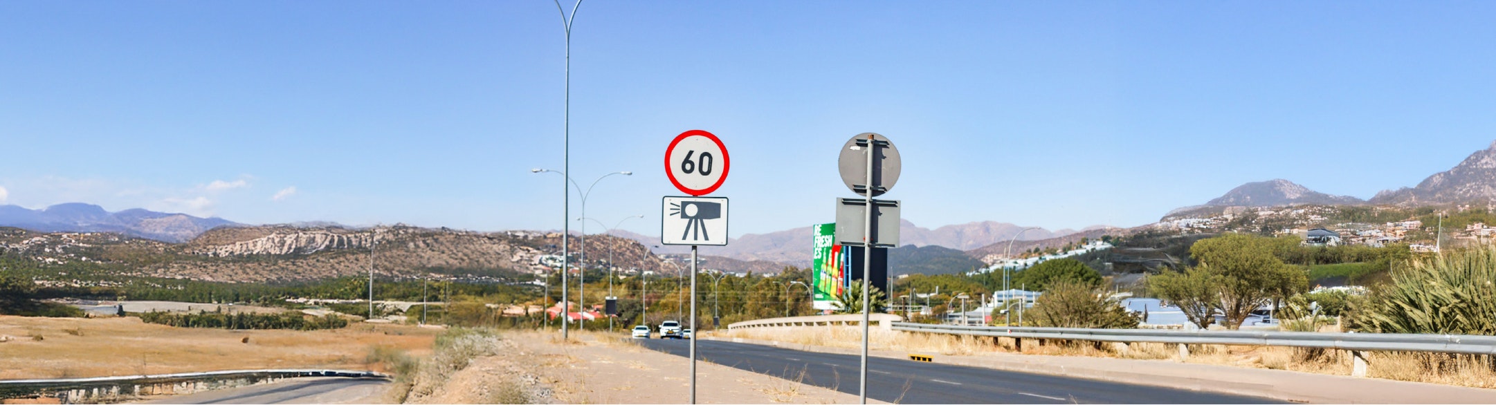 Road with speed limit sign in foreground