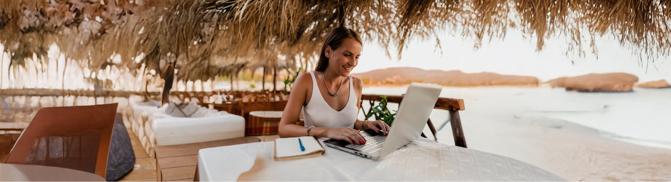 woman at table working on laptop
