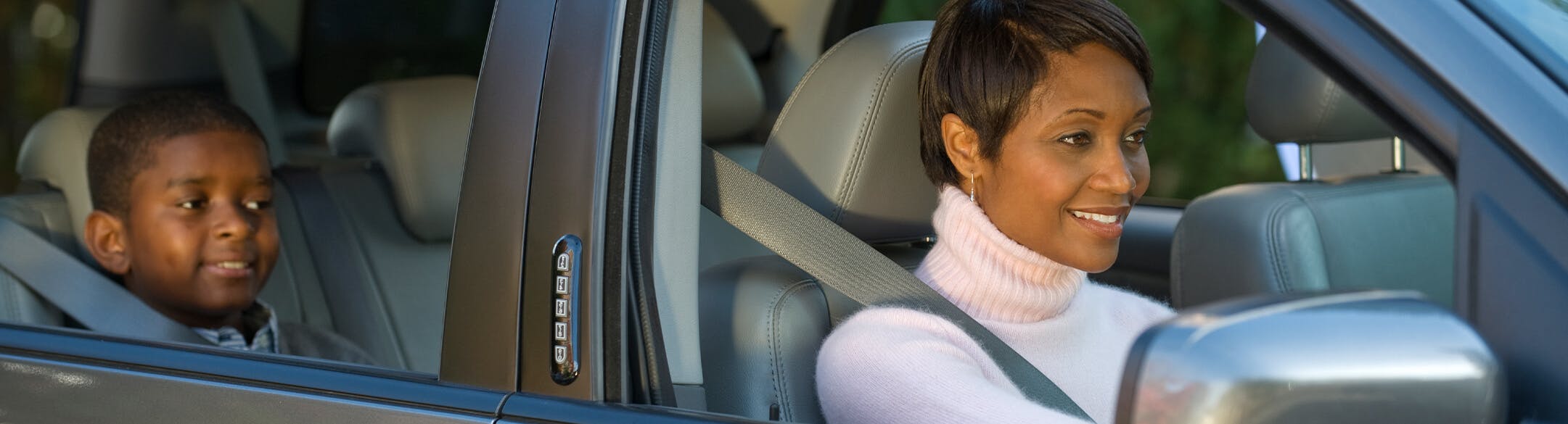 woman and child driving in car