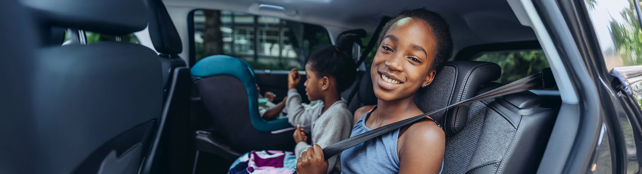 two children in back of robotaxi