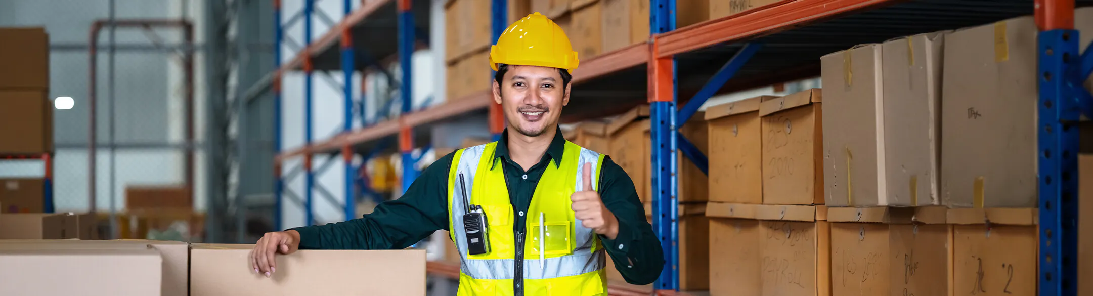 Man in warehouse wearing hard hat