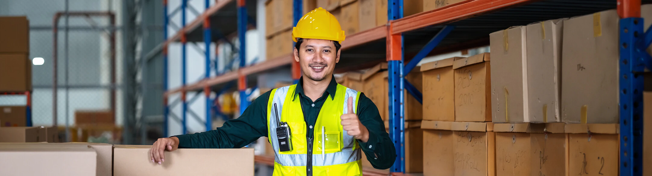 Man in warehouse wearing hard hat