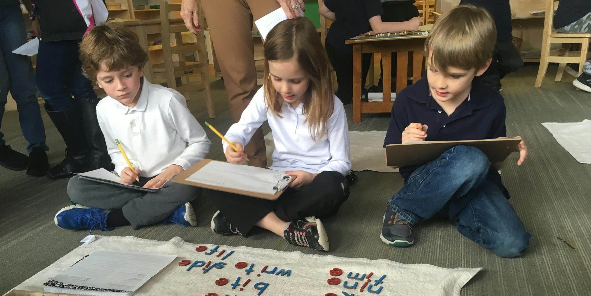 Three kids doing an activity in class