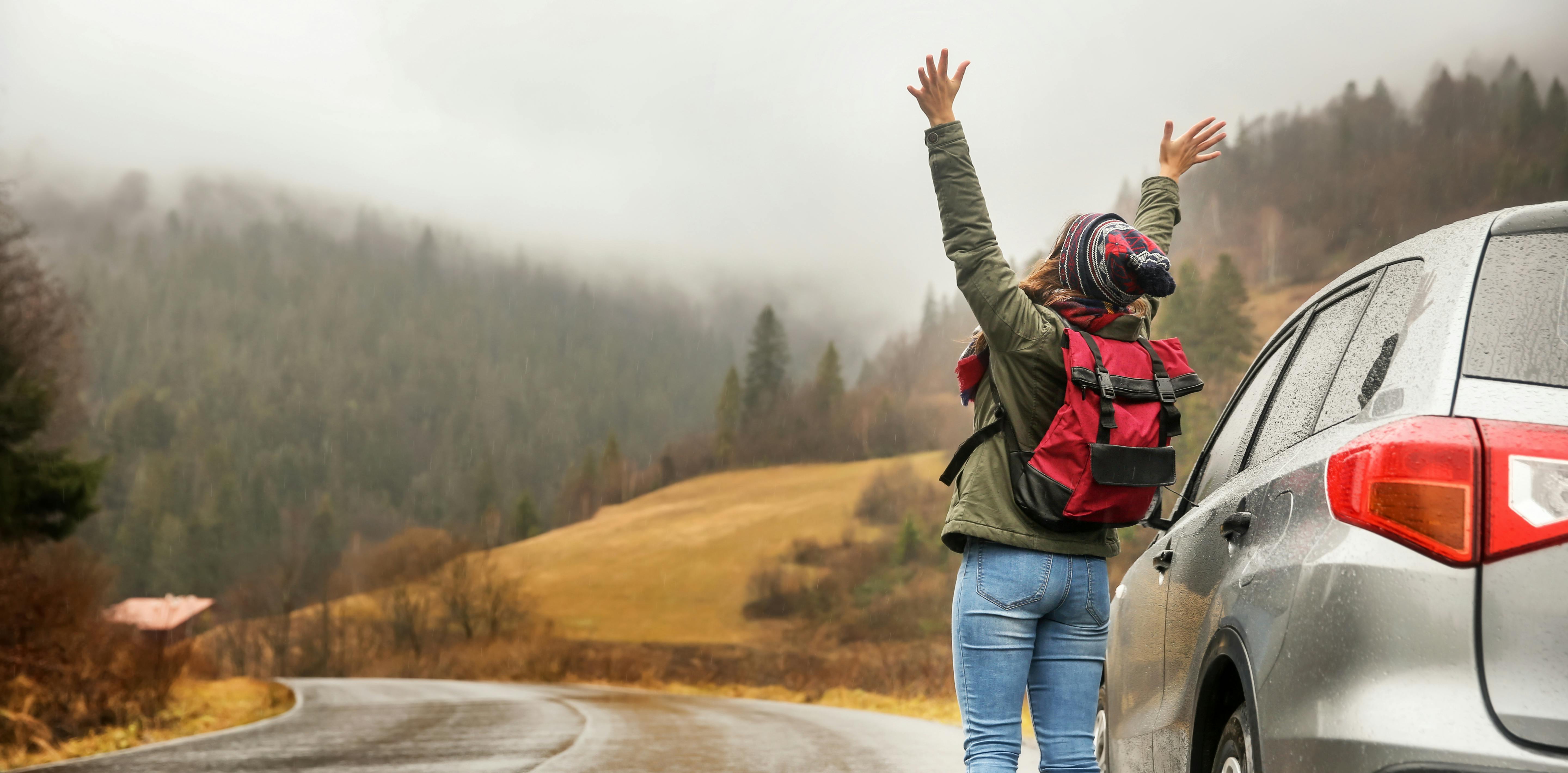 Woman outside car looking onto sights