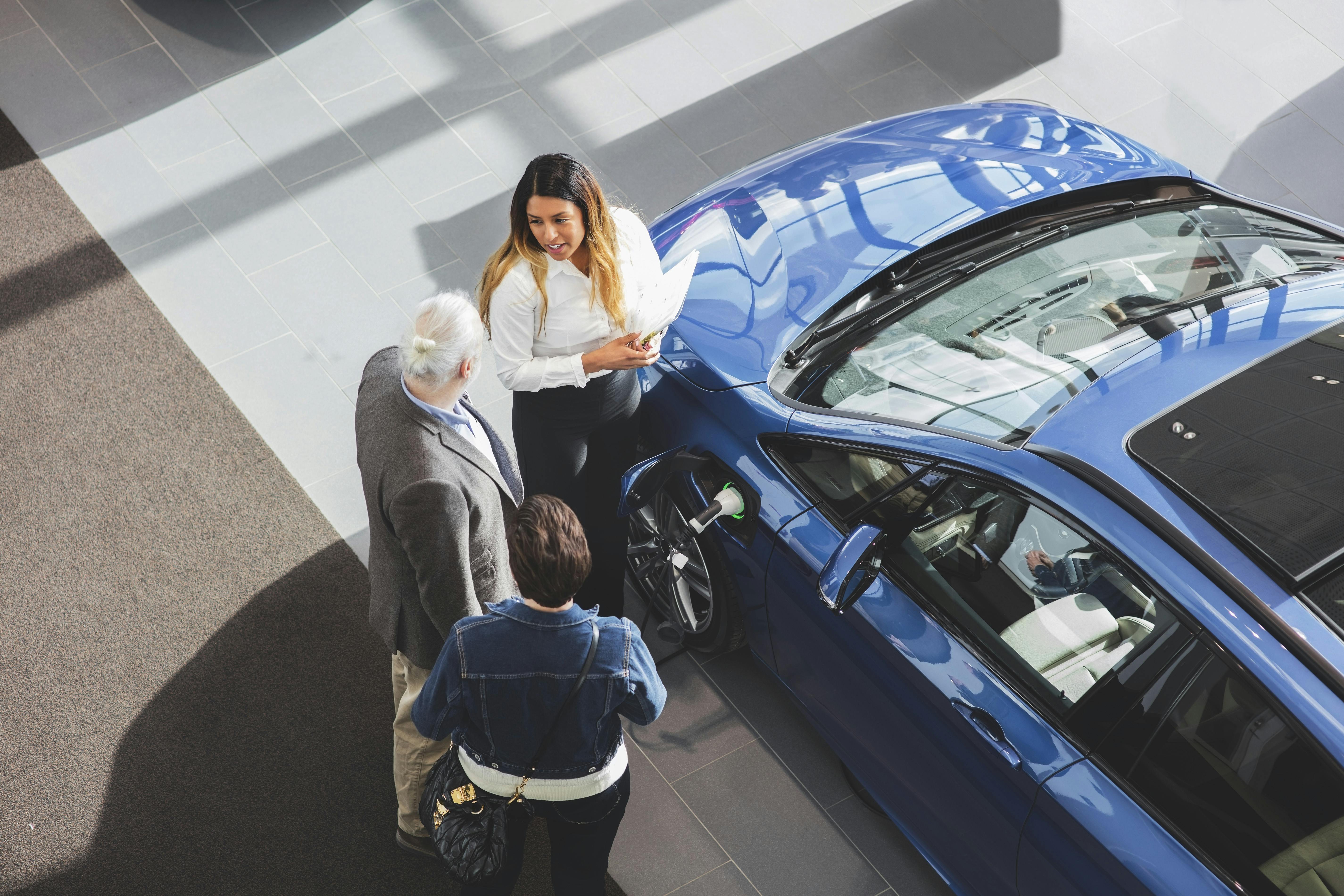 Dealer and Customers Viewing an Eclectic Vehicle 