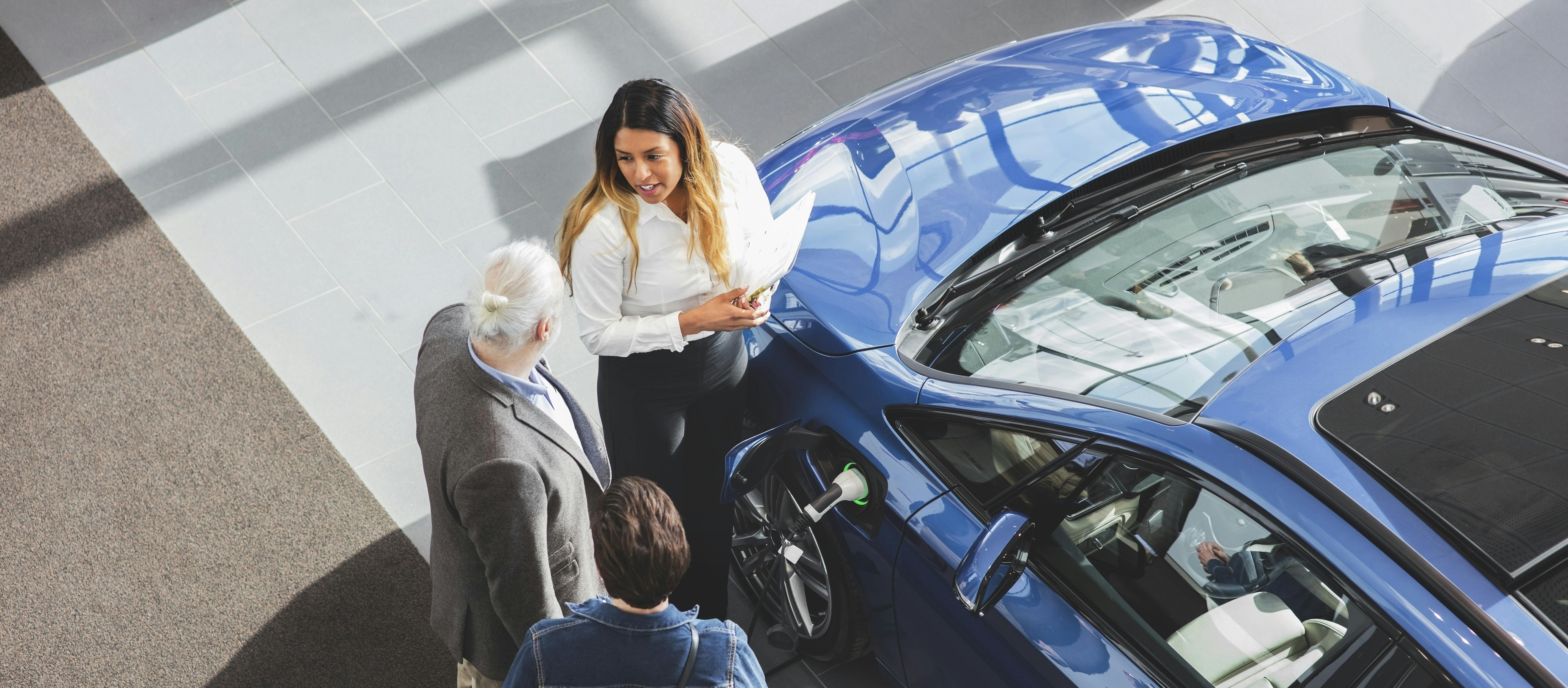 Dealer and Customers Viewing an Eclectic Vehicle