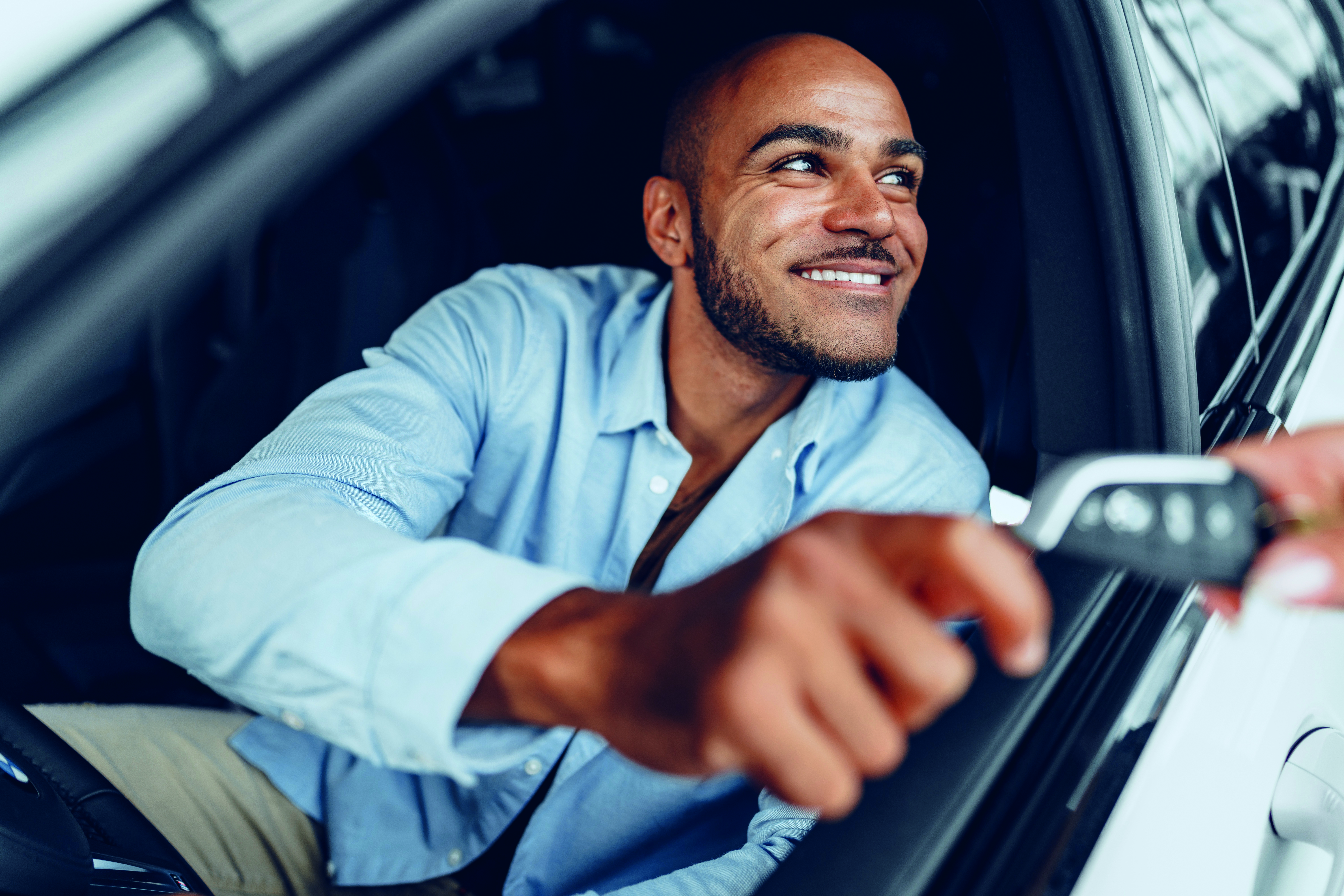 Man in car, taking his car key