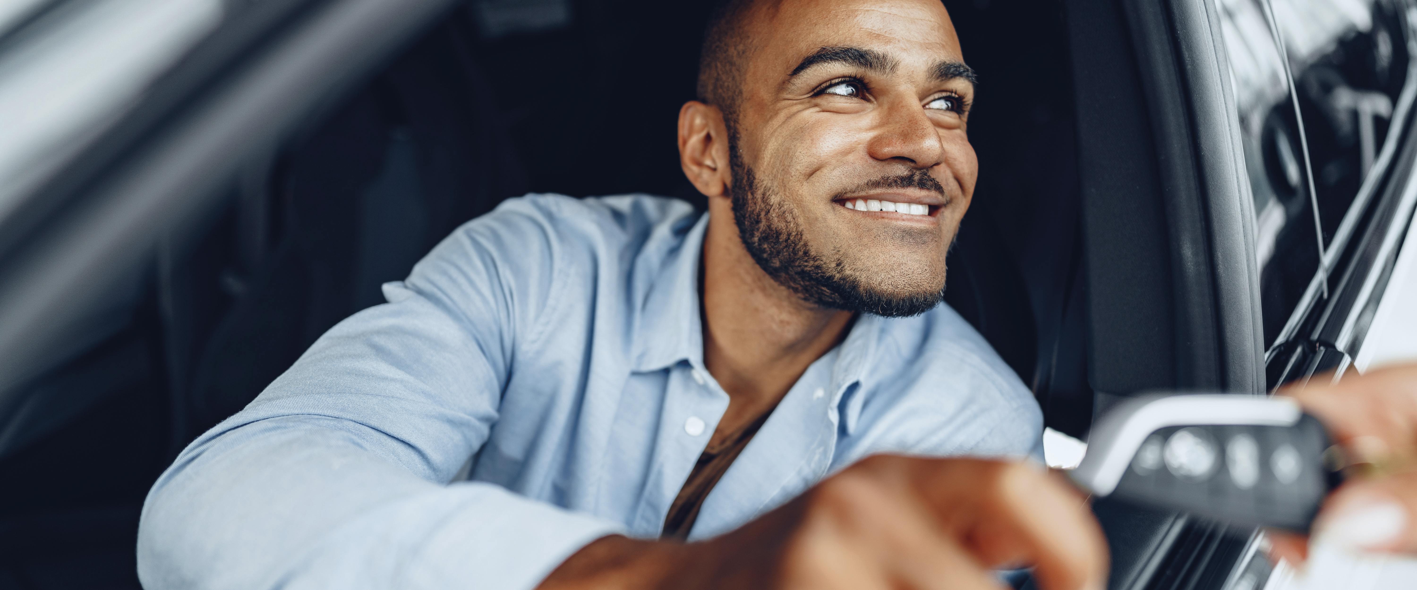 Man in car, taking his car key