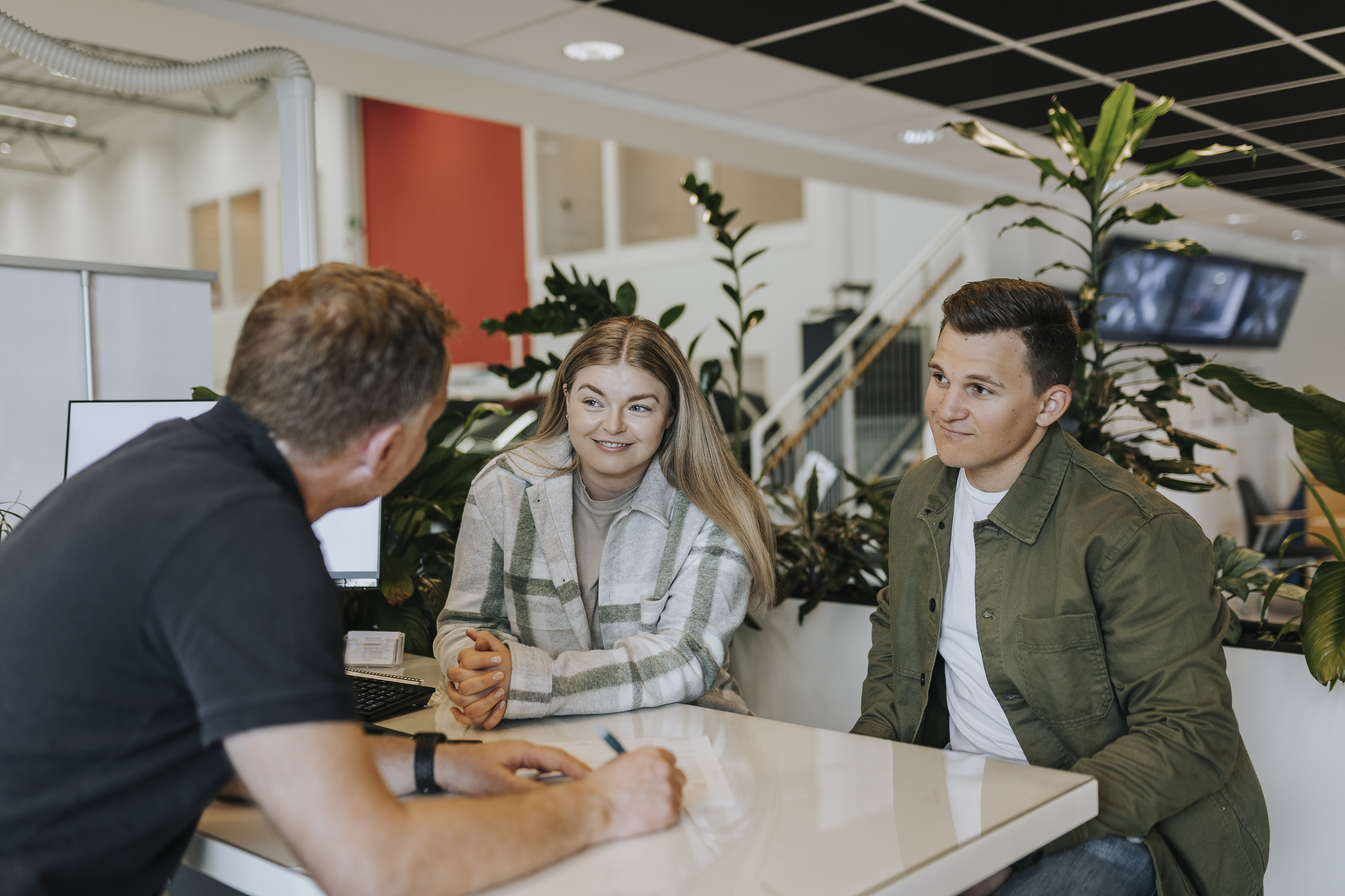 Couple at a table with a car dealer