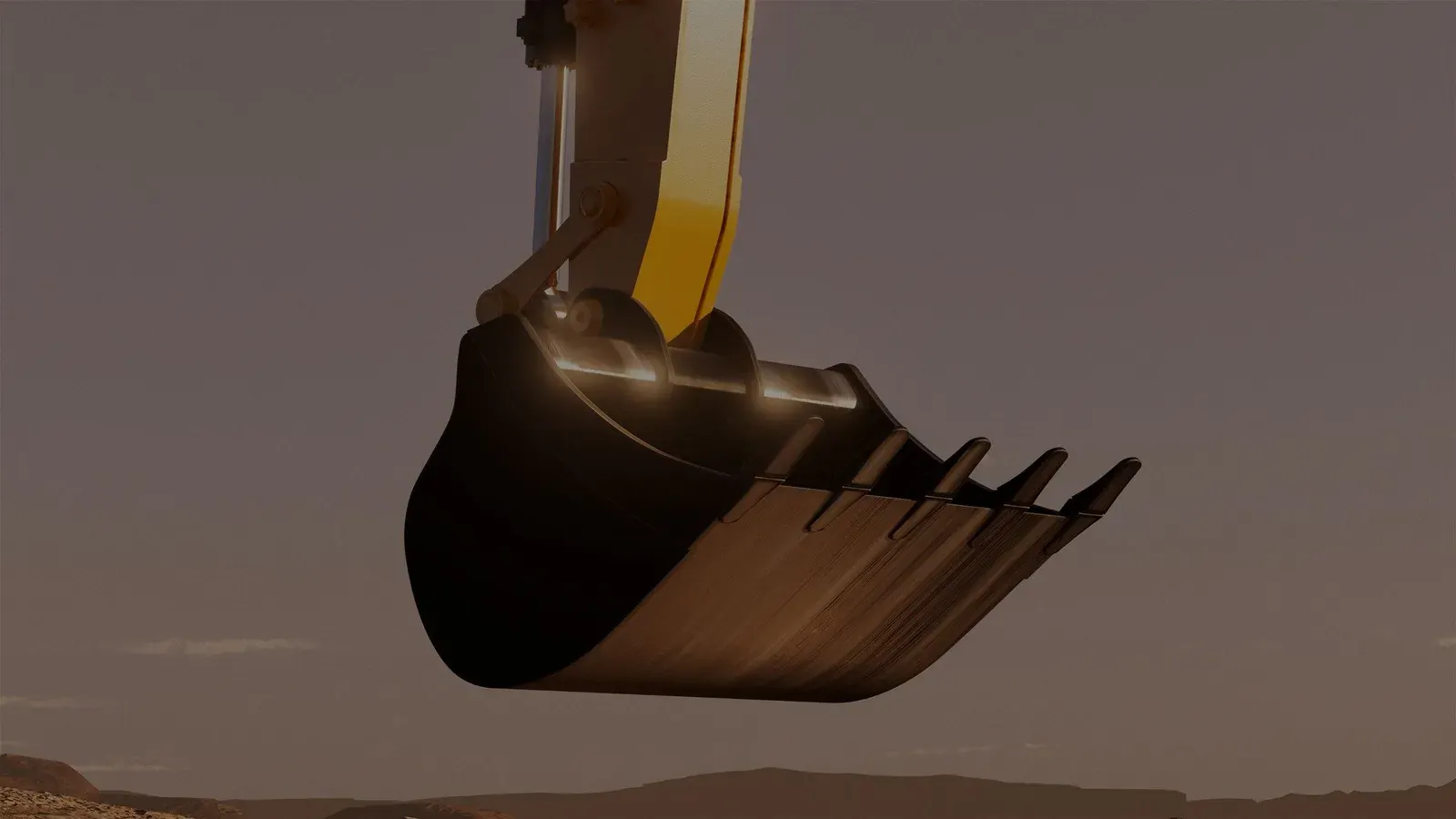 Excavator bucket lifted over a job site