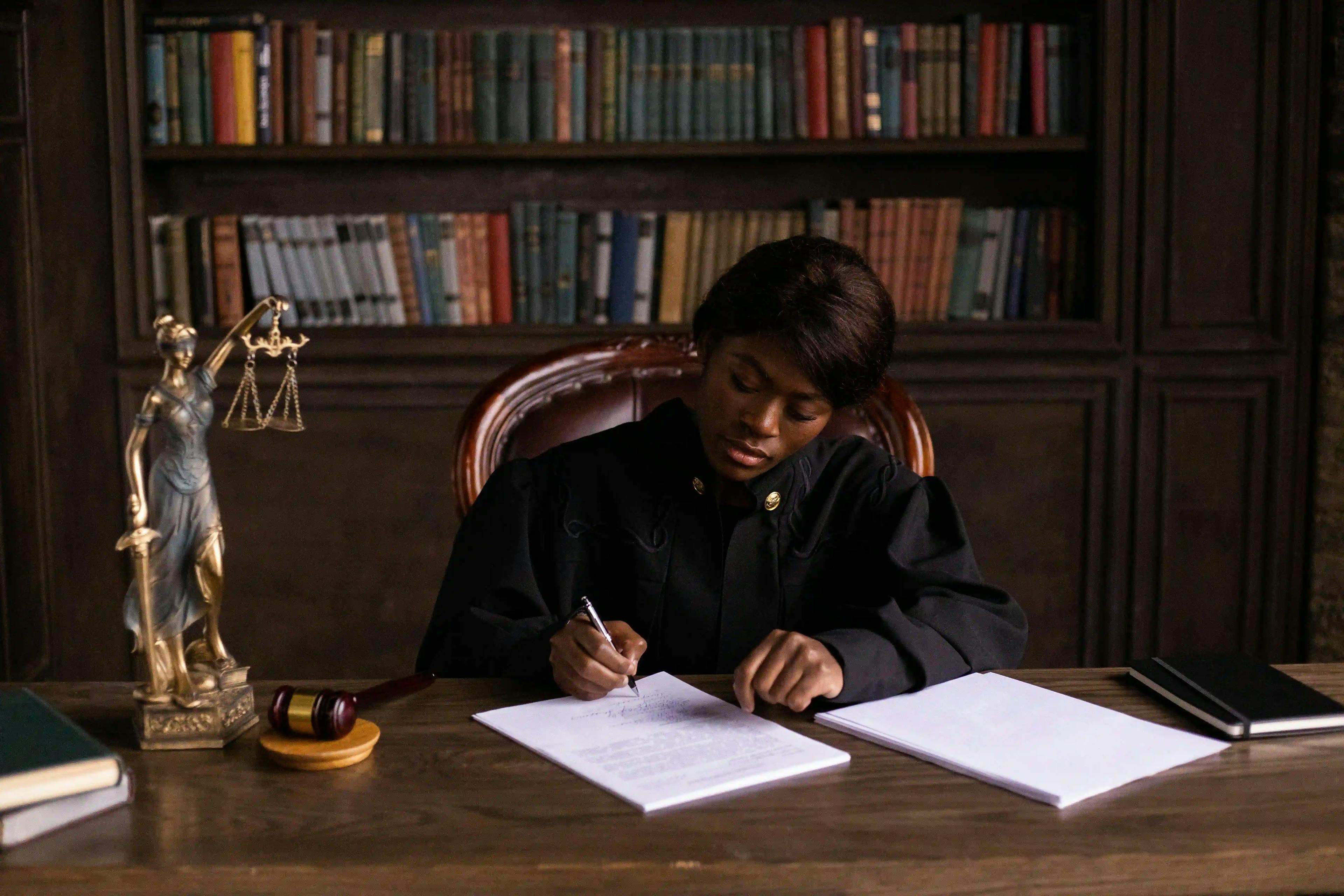 female judge signing papers