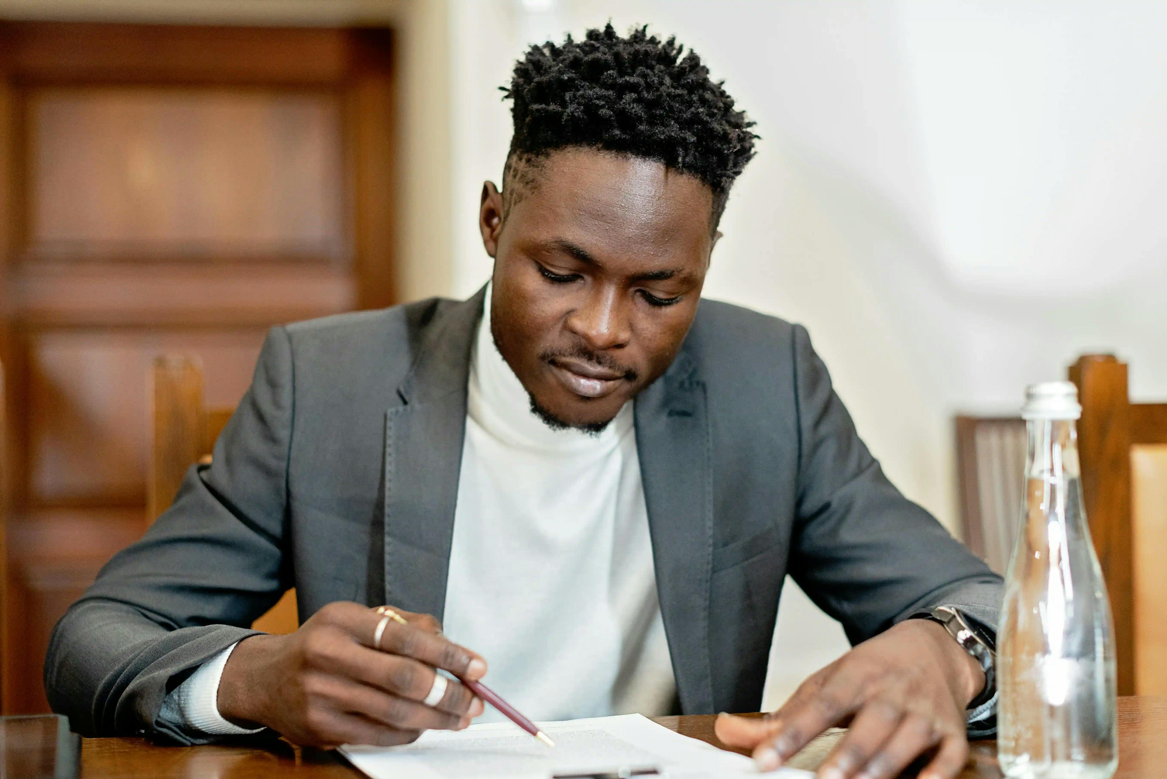 man signing documents