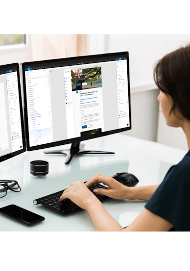 Woman working on multiple screens looking at Novartis design system