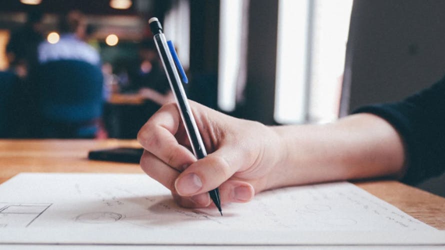 A hand of a woman writing something down