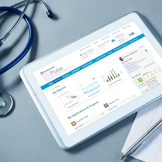 a tablet on a doctor's desk with the Cleveland Clinic site on it