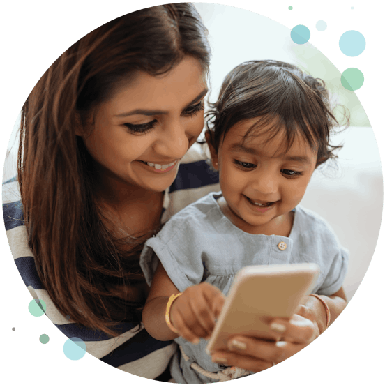 a mother with her son looking at a phone