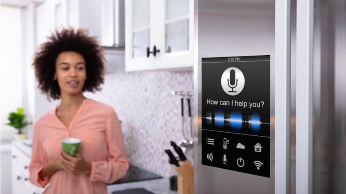 Woman standing next to a voice assistant device