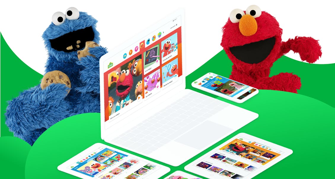 The cookie monster and Elmo in a green and white background with a computer and phones with the Sesame site in it.