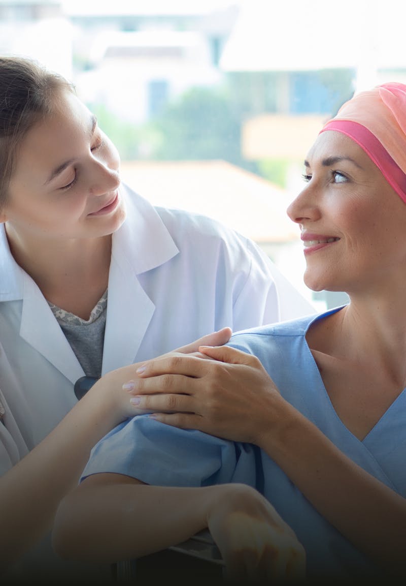 Chemotherapy patient and doctor smiling at each other