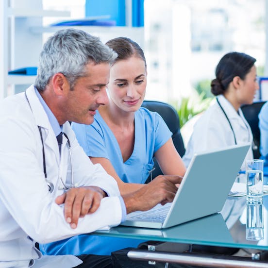 two doctors looking at a computer