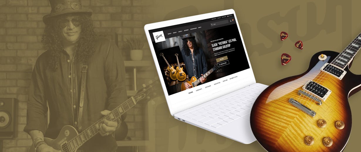 Slash on the background and at the front a guitar and a laptop with Gibson.com on the screen