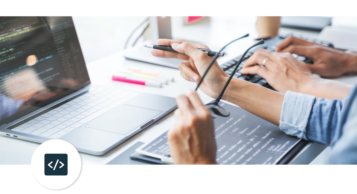 two people looking at a computer with the technology logo in the corner