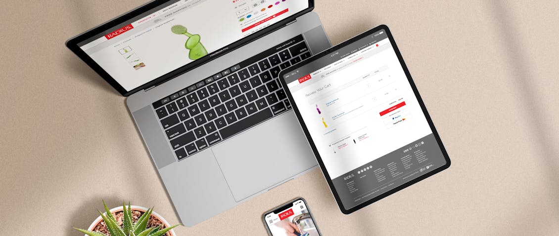 Shown from above the Radius site on a computer, an ipad and a cellphone