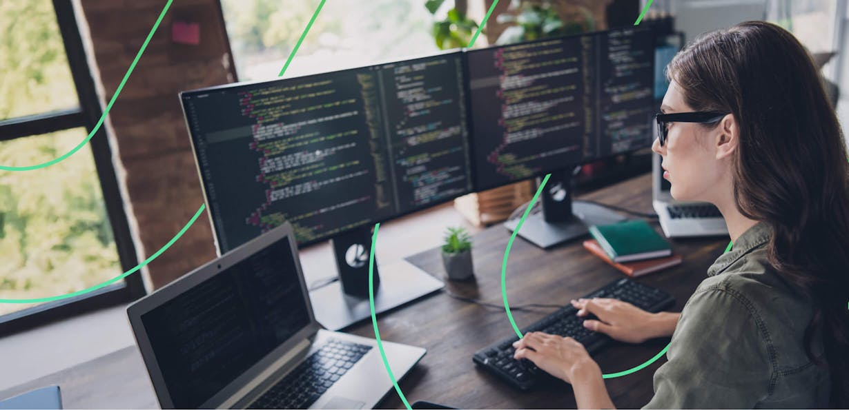 Woman working on multiple computer monitors