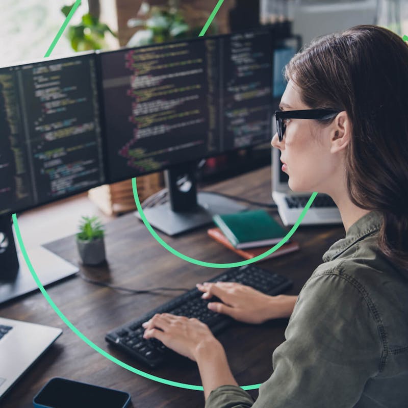 woman working on multiple screens