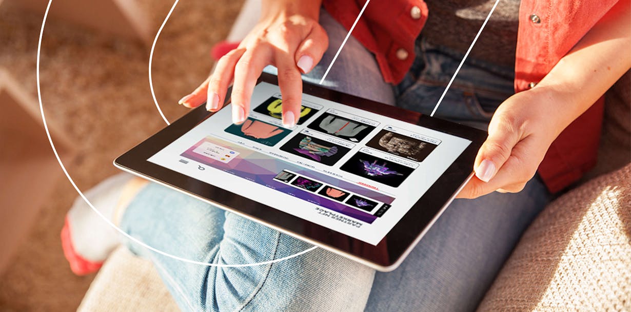 Hands interacting with tablet shopping for sweaters