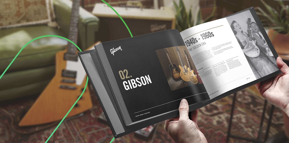 A Gibson guitars brand book is held open