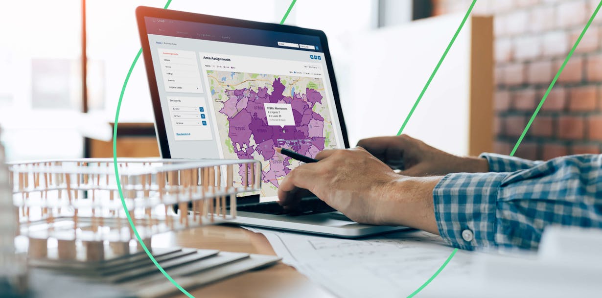 Hands typing on a laptop with a map on screen