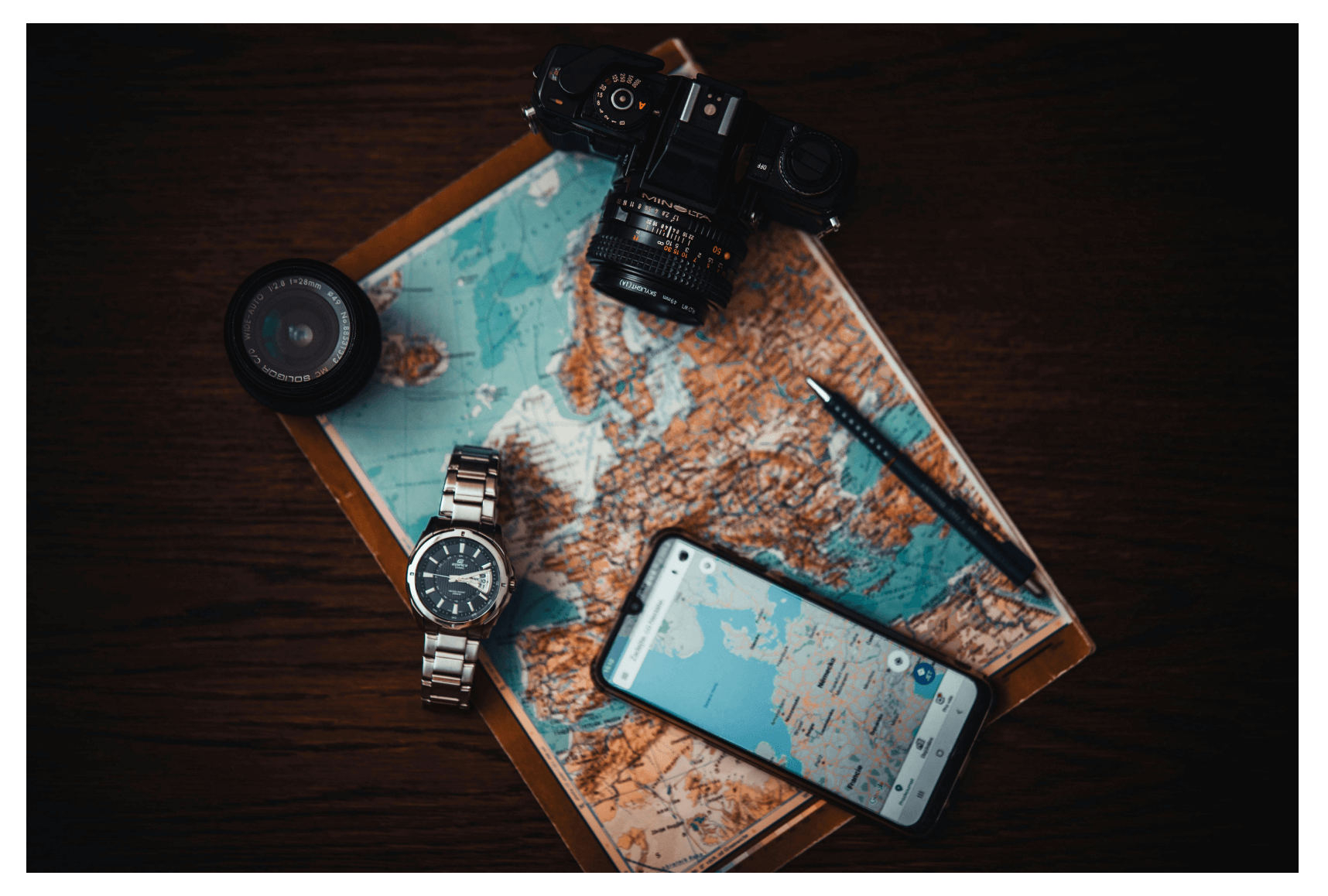 Mockup of a travel app with travel accessories (map, camera, watch, compass)