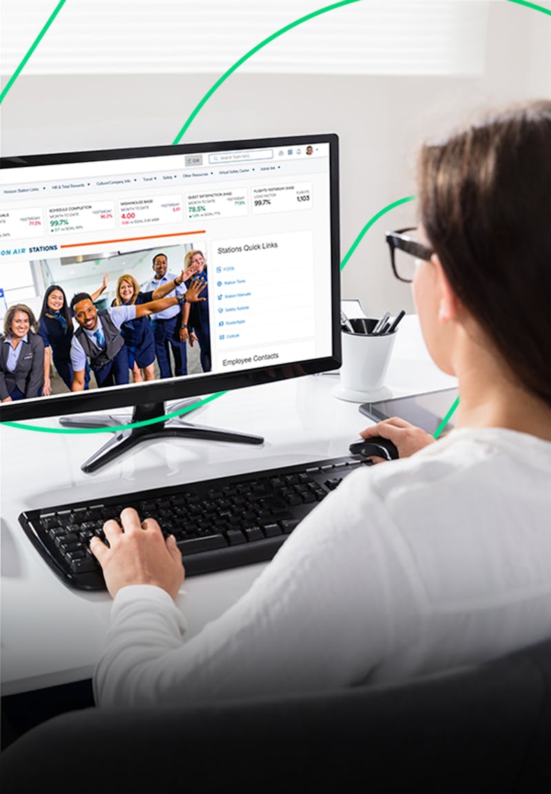 Woman viewing Alaska Airlines intranet on a computer screen