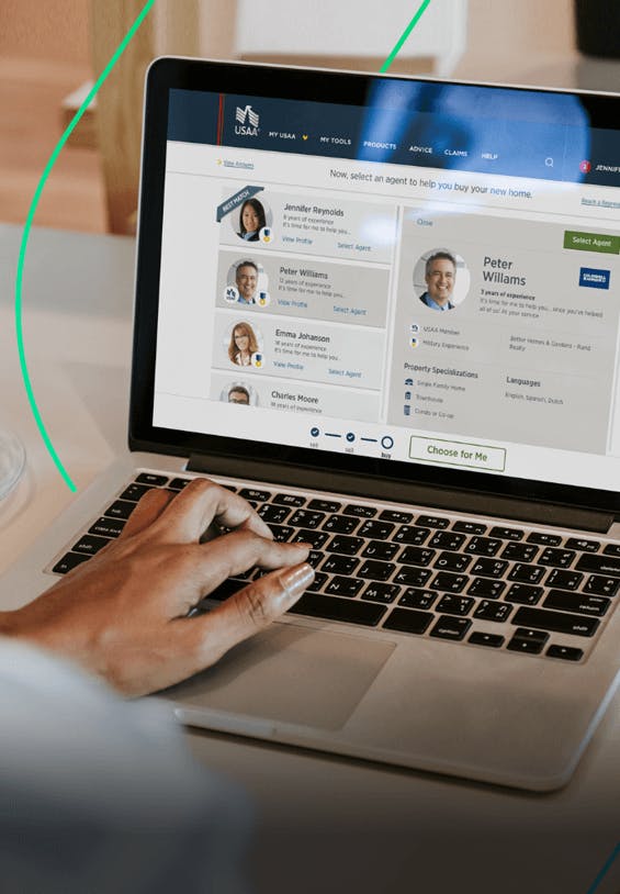 a hand using a laptop with one of the USAA site screens