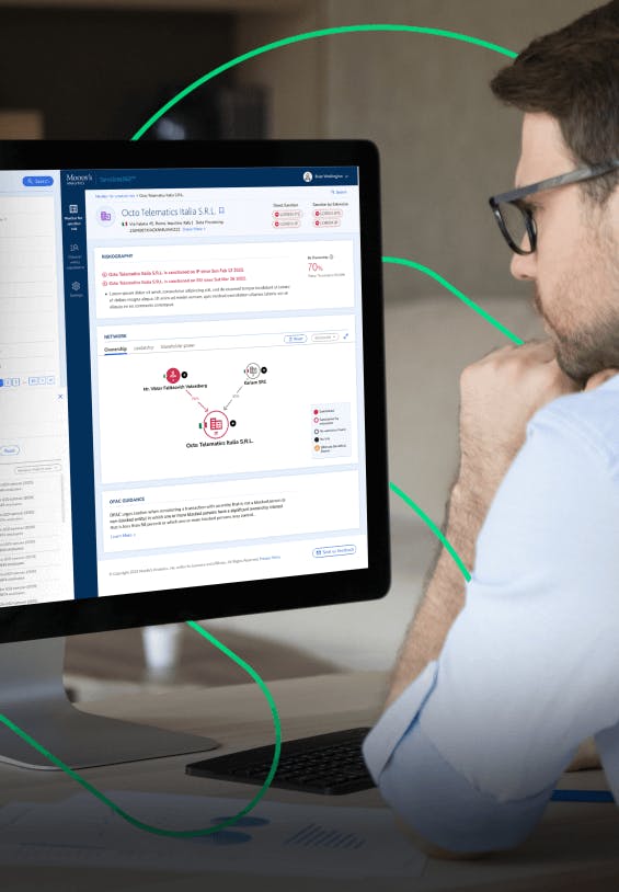 Man looking at the Moody's interface on a computer screen