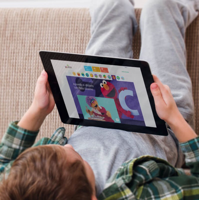 child laying on the floor with a tablet