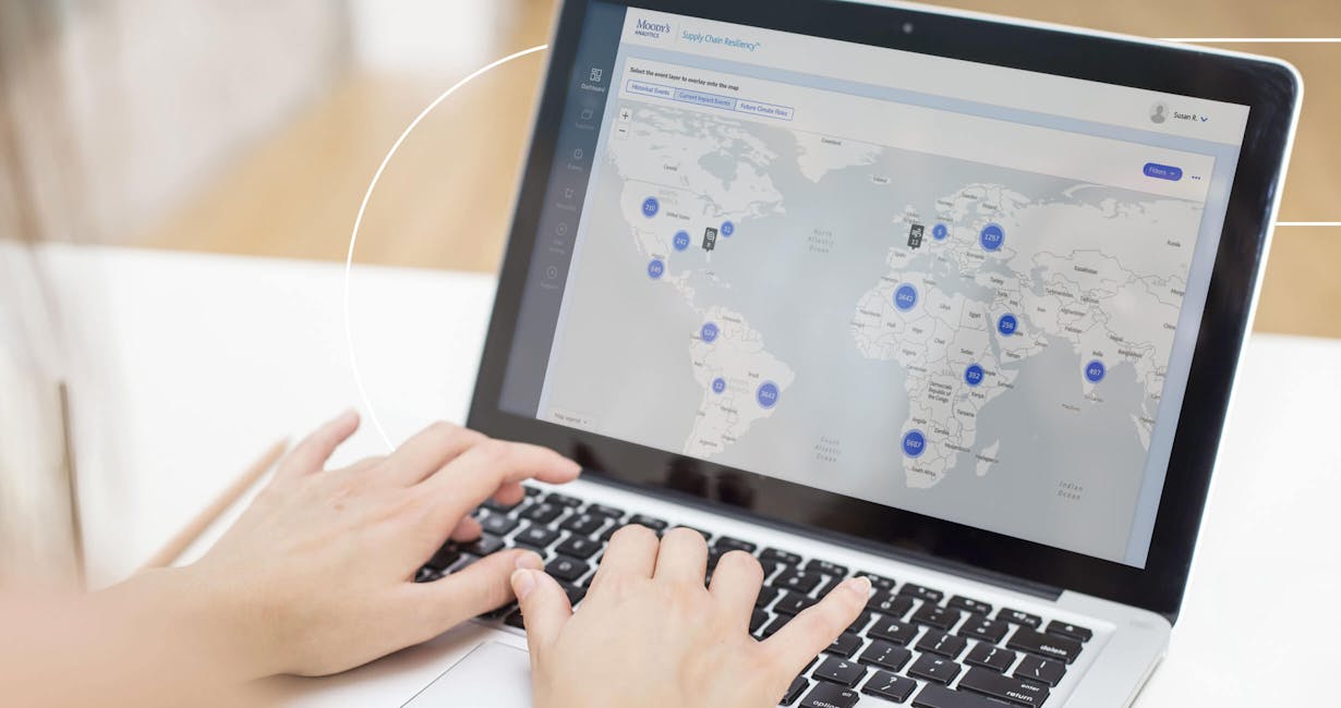 Person typing on a laptop with map on the screen