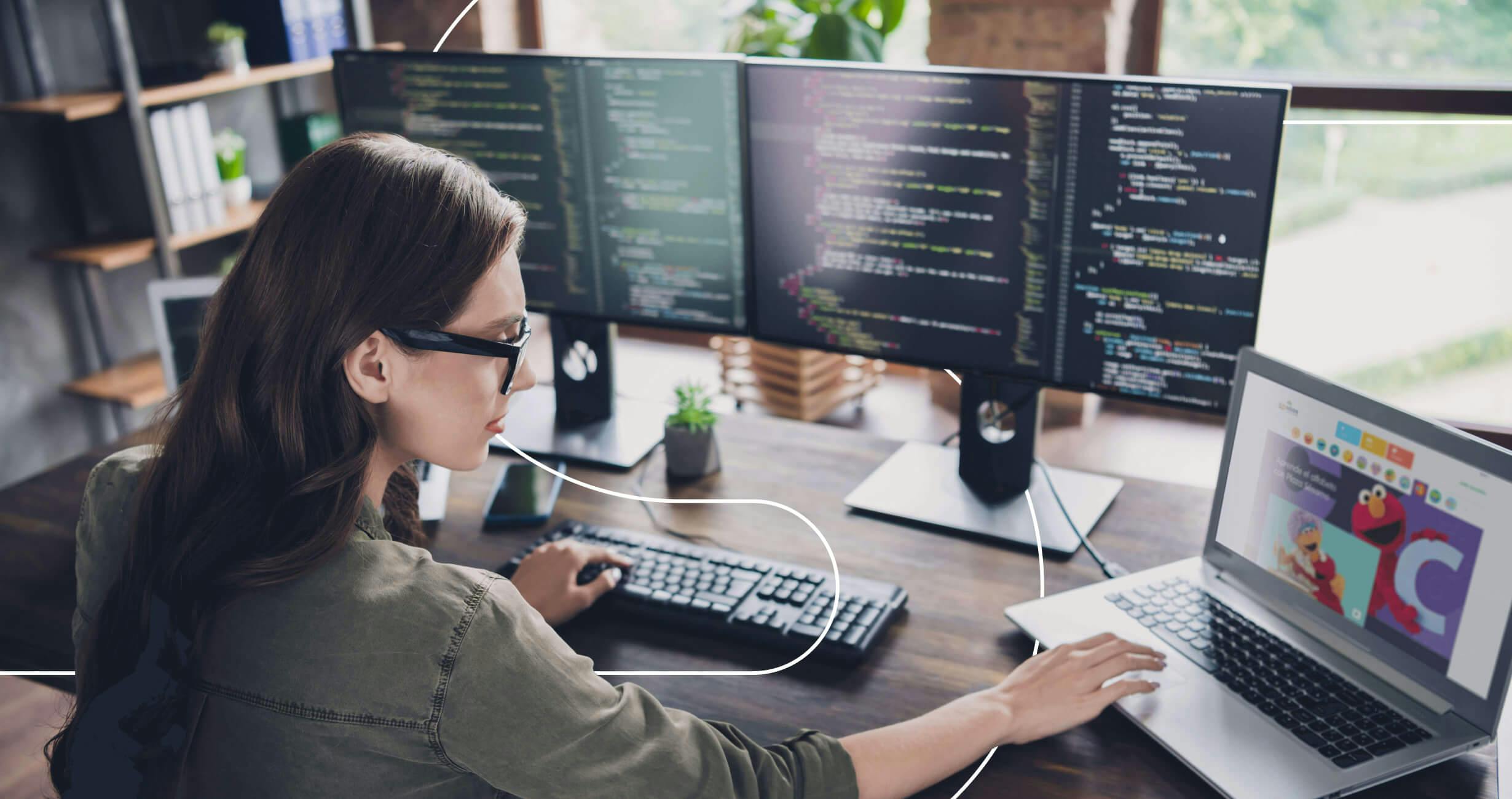 woman working on multiple screens