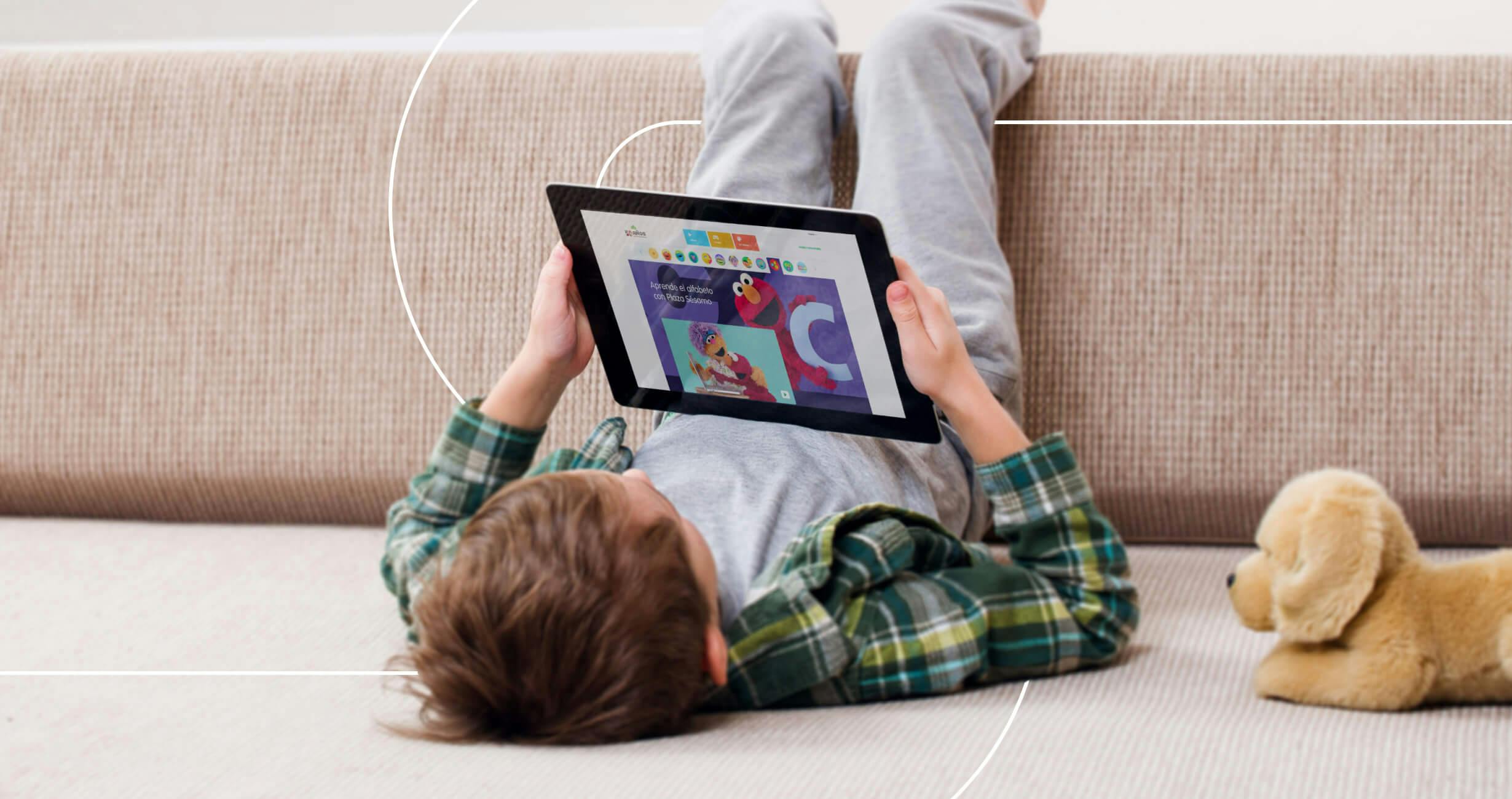 Child on the floor with a tablet