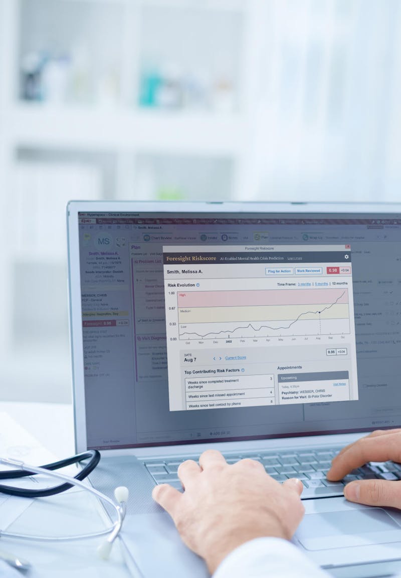 Doctor typing on a laptop